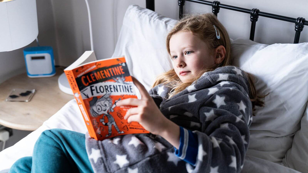 A girl reading in bed