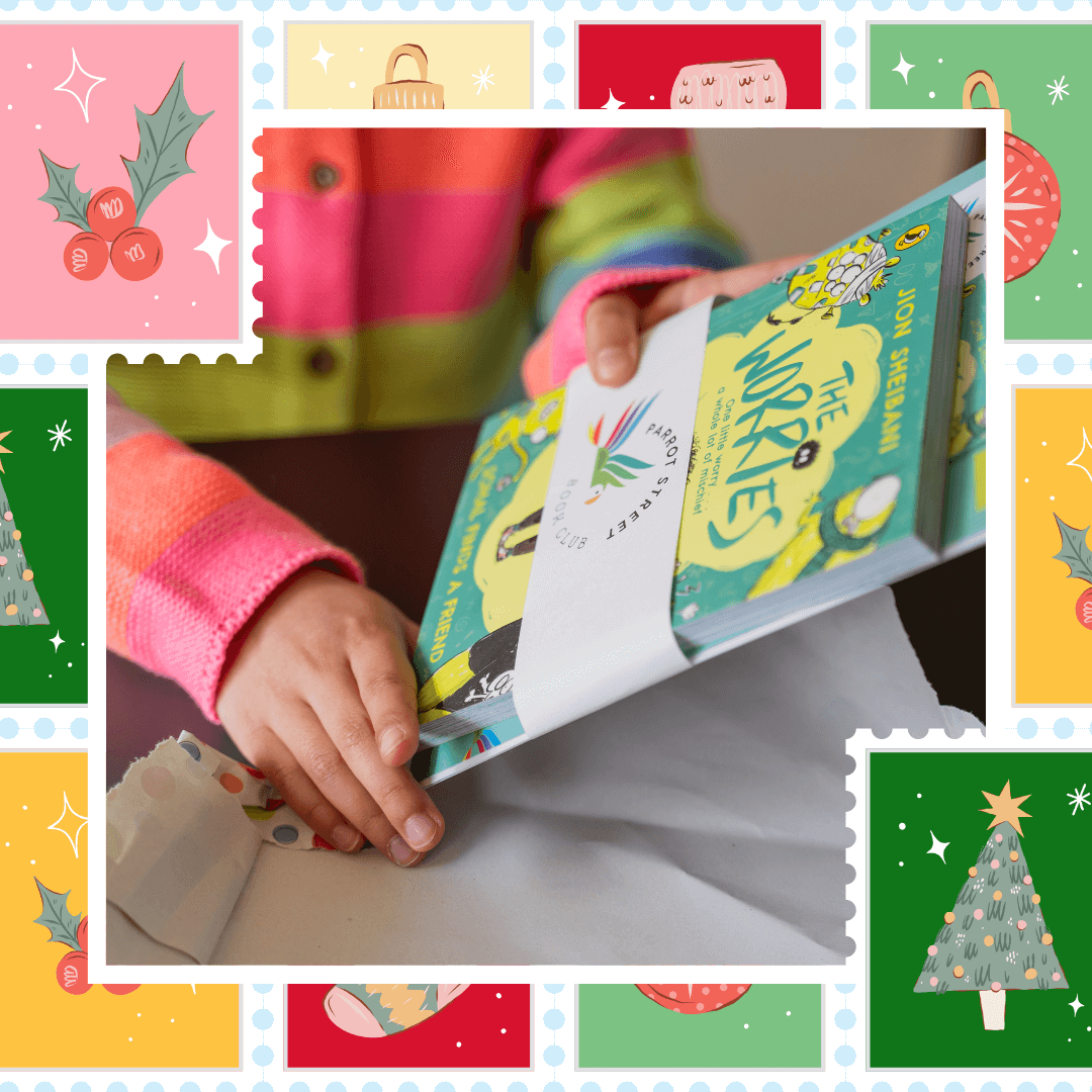 Child's hands holding a subscription book and activity pack bundle