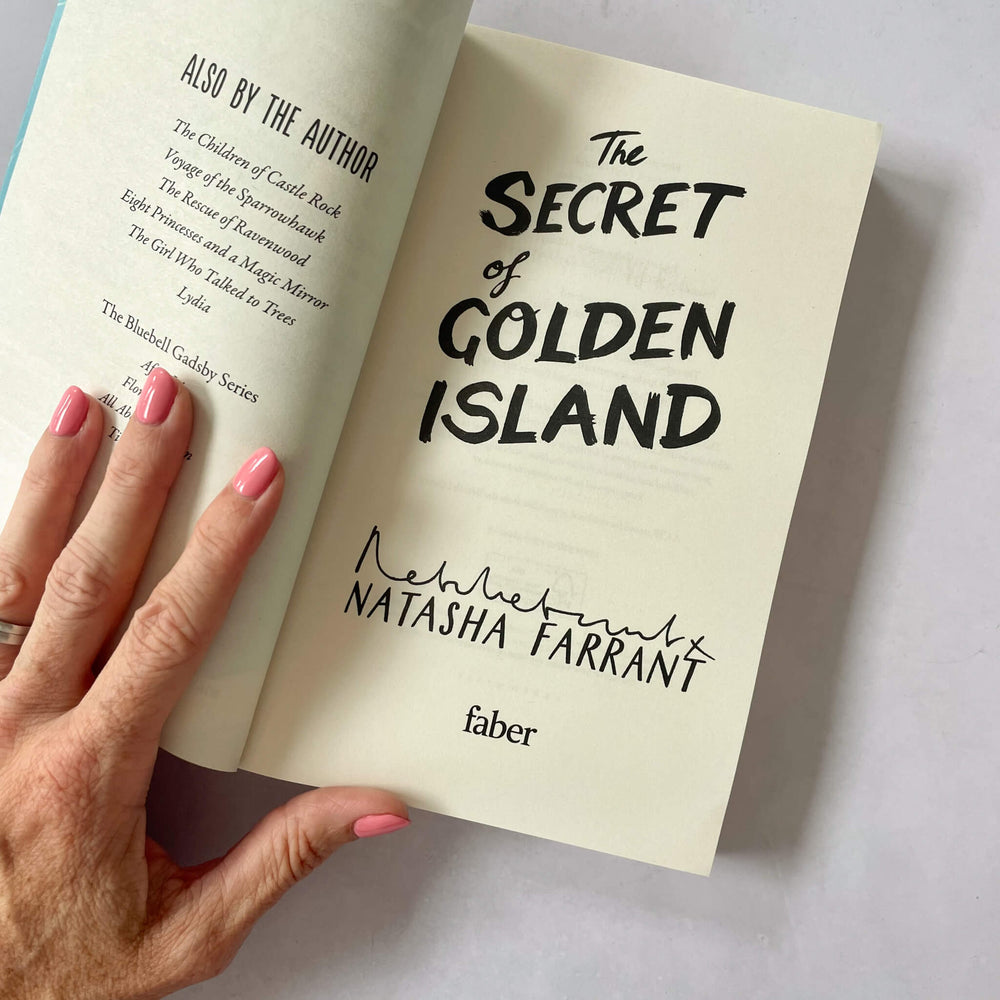 Open copy of The Secret of Golden Island showing it's signed by author Natasha Farrant